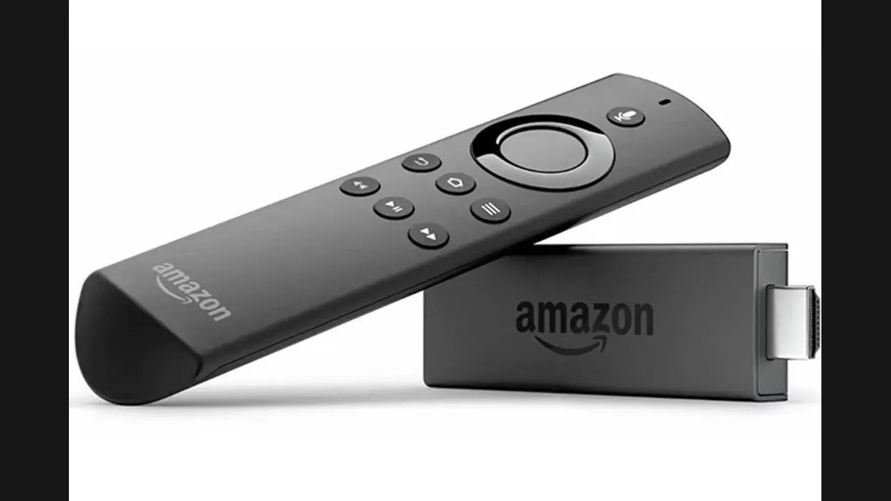 An Amazon Fire TV Stick streaming stick beside its voice remote on a white background