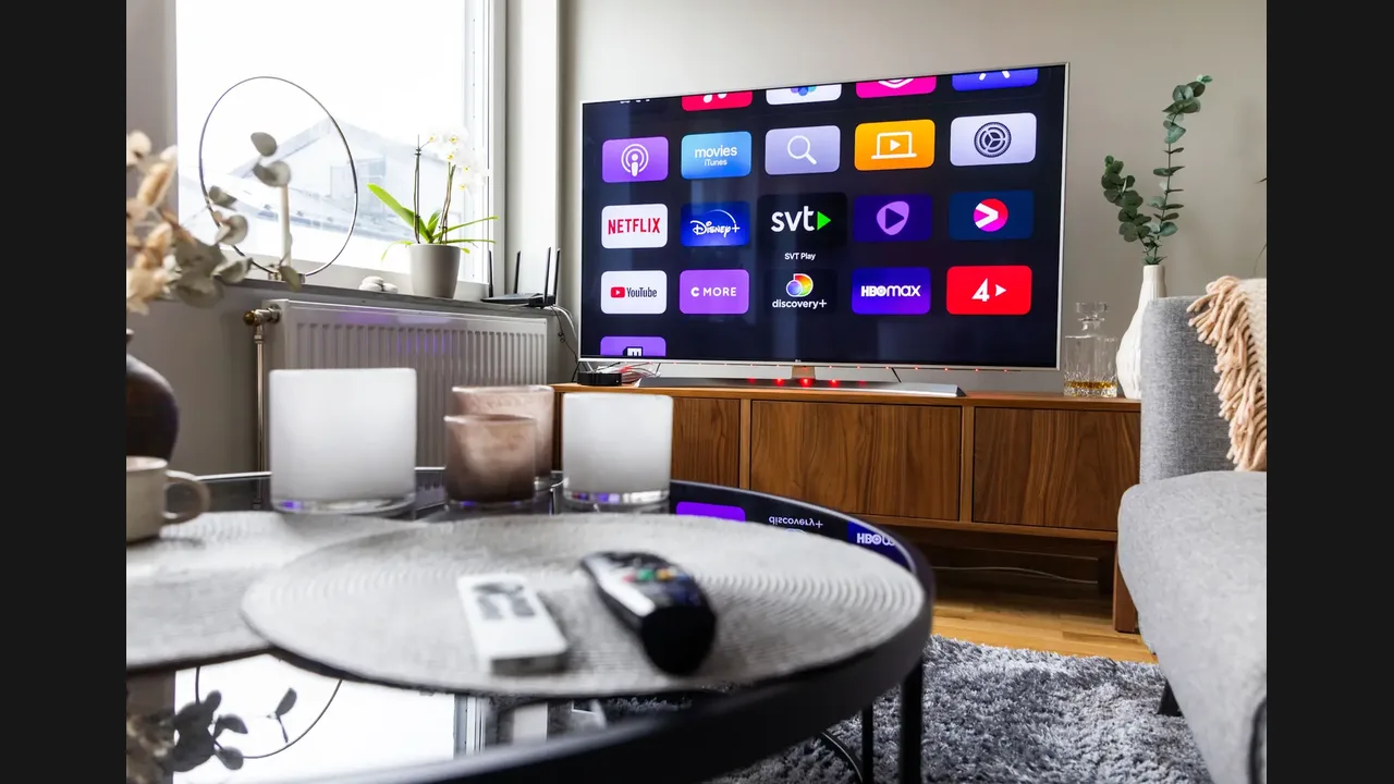 A living room television showing a grid of streaming apps, with remotes on a coffee table